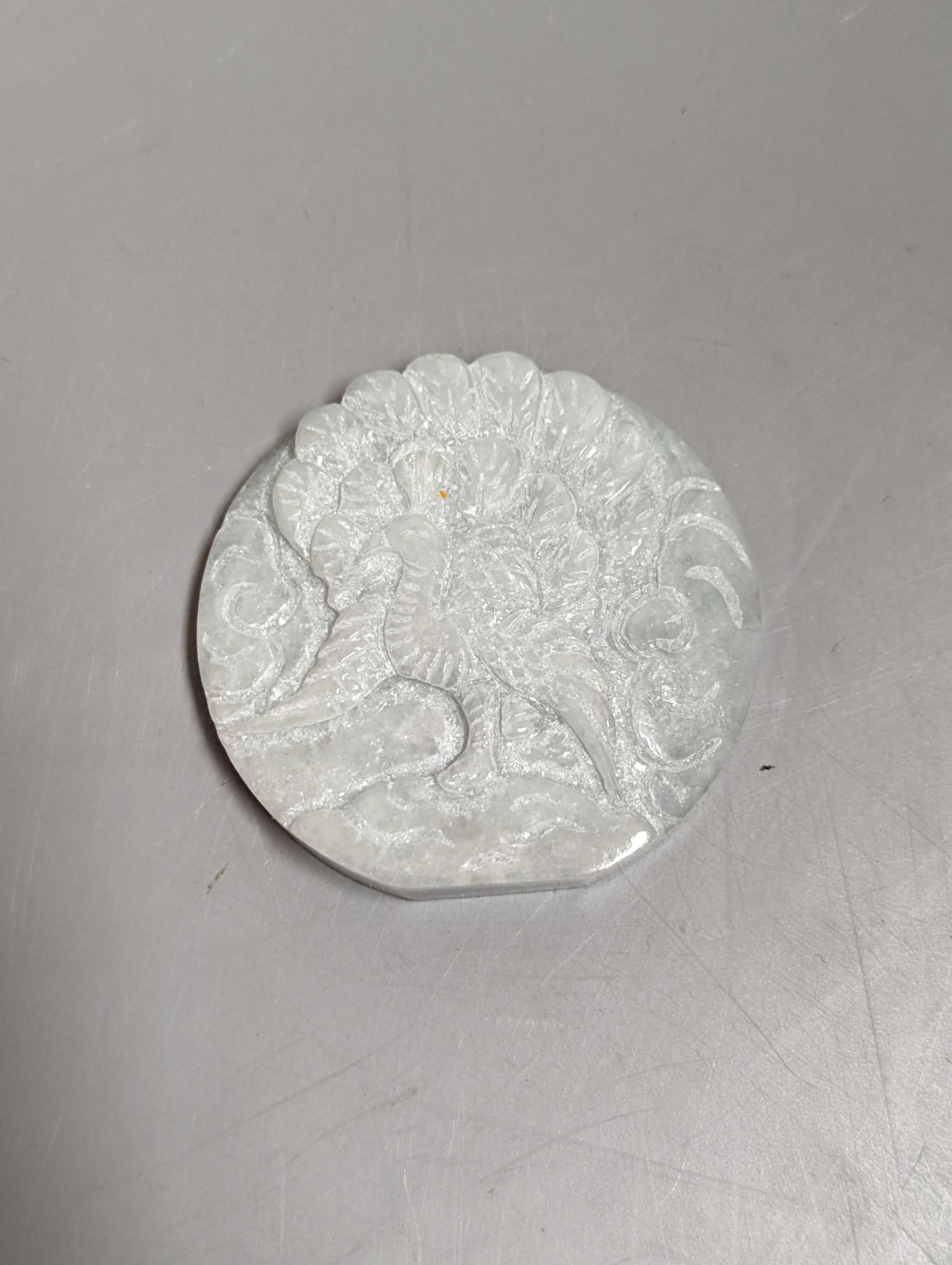 A Chinese bowenite jade handled magnifying glass, (14 cms long) and a jadeite peacock plaque